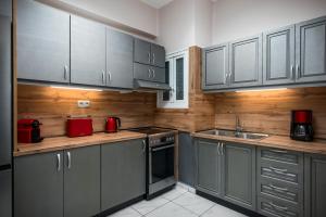a kitchen with gray cabinets and a sink at Corfu City Center Design Residence incl private parking in Corfu