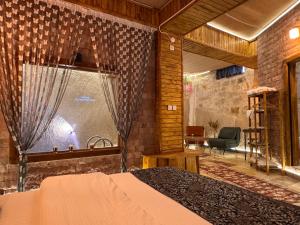 a bedroom with a bed and a large window at Ceran Stone House in Göreme +76 photos
