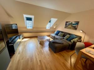 a living room with a couch and a table at Apartments Aarbergergasse - Self Check-In in Bern
