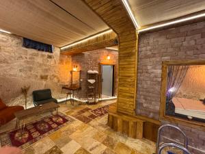 a living room with a couch and a mirror at Ceran Stone House in Göreme