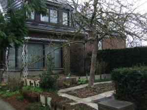 a house with a tree in the front yard at Bij het station van Drongen in Ghent +4 photos