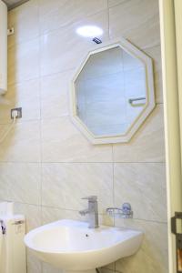a bathroom with a sink and a mirror on the wall at HD Residential Apartment , Bole Dembel in Addis Ababa +35 photos