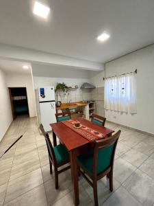 a kitchen with a table and chairs and a refrigerator at Cabana Alojamiento Turistico in Humahuaca