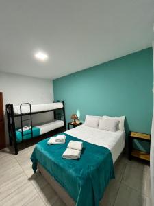 a bedroom with a bed with a blue wall at Cabana Alojamiento Turistico in Humahuaca