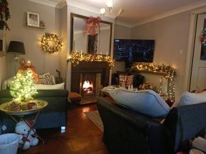 a living room with a fireplace and christmas lights at Ashleigh House Bed & Breakfast in Monaghan