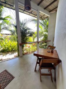a wooden table and a chair in a room at Poolside Cabaña Studio with stunning ocean view in Puerto Escondido