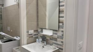 a bathroom with a sink and a mirror at Casa di Leo in Loano +30 photos