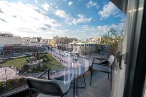 a balcony with chairs and a view of a city at Esperia Hotel in Larisa