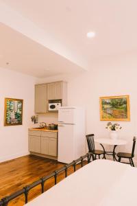 a kitchen with a white refrigerator and a table at The Historic Hattie House in Abingdon