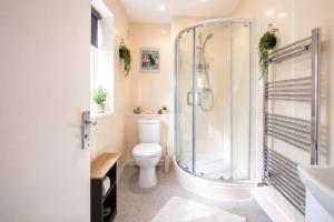 a bathroom with a shower and a toilet at Brighton Colour Pop House- Sleeps up to 12 in Brighton & Hove