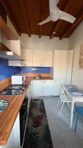 a kitchen with white cabinets and a stove top oven at La casetta in Cesano Maderno