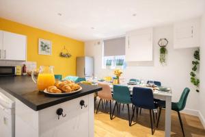 a kitchen with a table with a bowl of food on it at Brighton Colour Pop House- Sleeps up to 12 in Brighton & Hove