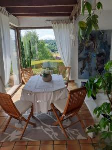 a dining room with a white table and chairs at Sérénité in Jussac
