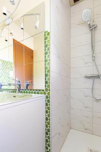 a bathroom with a shower and a sink and a mirror at Sérénité in Jussac +37 photos