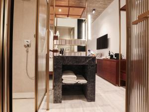 a bathroom with a shower and a sink with a counter at The Nines in Ayia Napa