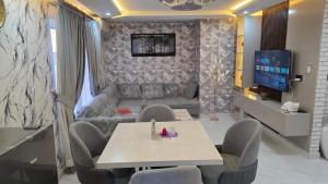 a living room with a couch and a table and chairs at Skyline Central Apartments in Islamabad +10 photos