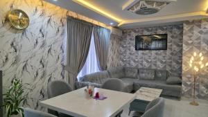 a living room with a couch and a table at Skyline Central Apartments in Islamabad