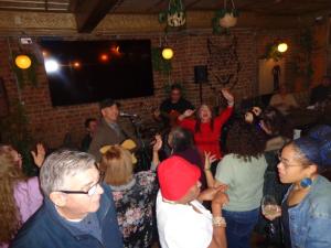 a crowd of people in a room with a microphone at The Wolfs Tavern in London