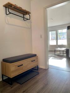 a room with a wooden dresser and a mirror at Ferienwohnung Sonnenplatz in Fehmarn