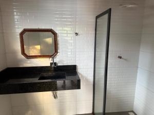 a bathroom with a sink and a mirror at Casa em Alter do Chão in Santarém +6 photos