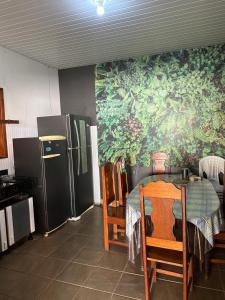 a kitchen with a table and a kitchen with a refrigerator at Casa em Alter do Chão in Santarém