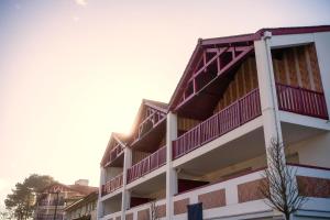 a building with red balconies on top of it at Grand appartement-lac-centre-hossegor in Hossegor