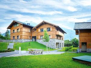 a large wooden building with a picnic table in front of it at Alpin Park Matrei in Matrei in Osttirol +17 photos