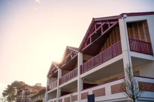 a building with red balconies on top of it at Grand appartement-lac-centre-hossegor in Hossegor