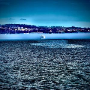 a boat in the middle of a large body of water at Ruhiges Apartment am See in Altnau