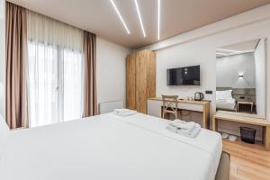 a hotel room with a bed and a mirror at Relax Inn Hotel Durres in Durrës