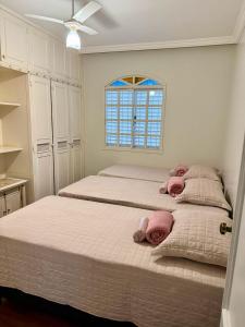 a bedroom with two beds and a window at Casarão José Morada in Belo Horizonte