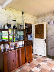 a kitchen with a wooden counter and a door at Cabana Refúgio do Recanto in São Valentim do Sul