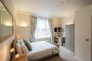 a bedroom with a bed and a window at Hunter House Holiday Apartment - York in York +14 photos
