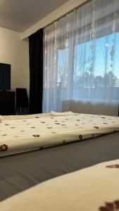 a large bed in a bedroom with a window at SCC2 Apartments in Cluj-Napoca +35 photos