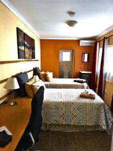 a hotel room with two beds in a room at Jolly Suites in Midrand +72 photos