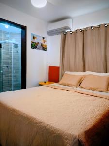 a bedroom with a large bed and a window at Apartamento Jacumã -Conde-PB in Conde +40 photos