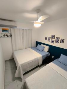 a bedroom with two beds and a ceiling at Apartamento Jacumã -Conde-PB in Conde