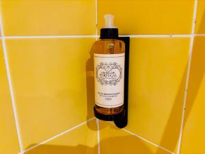 a bottle of soap is hanging on a tiled wall at Cine Studios PT in Setúbal