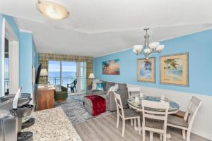 a dining room and living room with a table and chairs at Amazing Oceanfront Home HS 4th Floor in Myrtle Beach