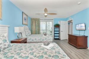 a bedroom with two beds and a ceiling fan at Amazing Oceanfront Home HS 4th Floor in Myrtle Beach +98 photos