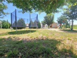 an empty park with a basketball hoop in the grass at Mobile Homes Peroš in Zaton