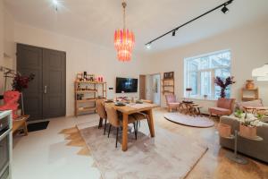 a living room with a table and a dining room at Rozā Dāvids in Liepāja