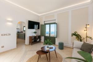 a living room with a couch and a table at Ocean Caldera View Villa by Dalmyra Estate in Imerovigli