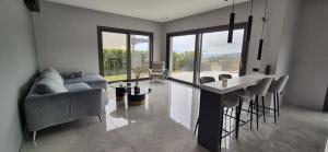 a living room with a couch and a table and chairs at Luxury Villa in Calabria in Gasponi