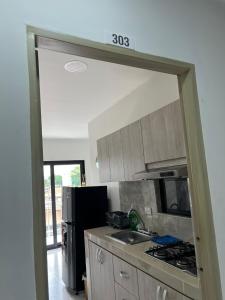 a kitchen with a sink and a stove top oven at Apartaestudio amoblado 303 Edificio Buenos Aires Sincelejo in Sincelejo