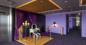 a purple room with a table and purple curtains at V Boutique Periférico Sur in Mexico City