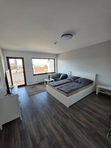 a large bedroom with a bed and a couch at Gemütliche Ferienwohnung in Mülheim-Kärlich