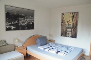a small bedroom with a bed and a couch at Wellness Apartments Sophienhöhe AM TEICH in Mechernich +27 photos