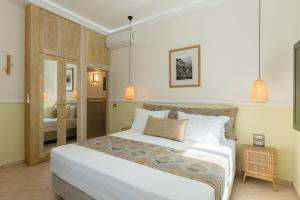 a bedroom with a large white bed in a room at Ocean Caldera View Villa by Dalmyra Estate in Imerovigli