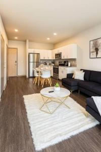 a living room with a couch and a table at Blackbeam Suite in Des Moines